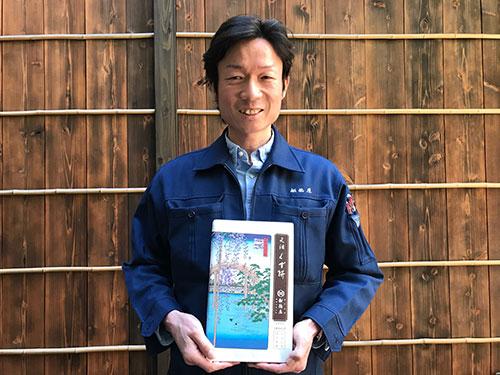 企画本部通販事業部・川妻智彦課長。手にしているのは人気商品の「元祖くず餅」